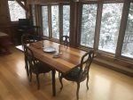 Cozy dining room with fresh snow outside